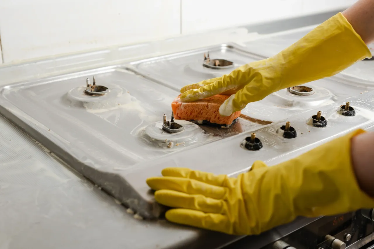 A stovetop being deep cleaned